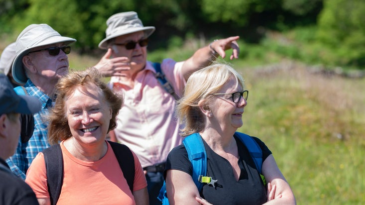 Visitors taking part in a guided walk around Tarn Hows, Cumbria
